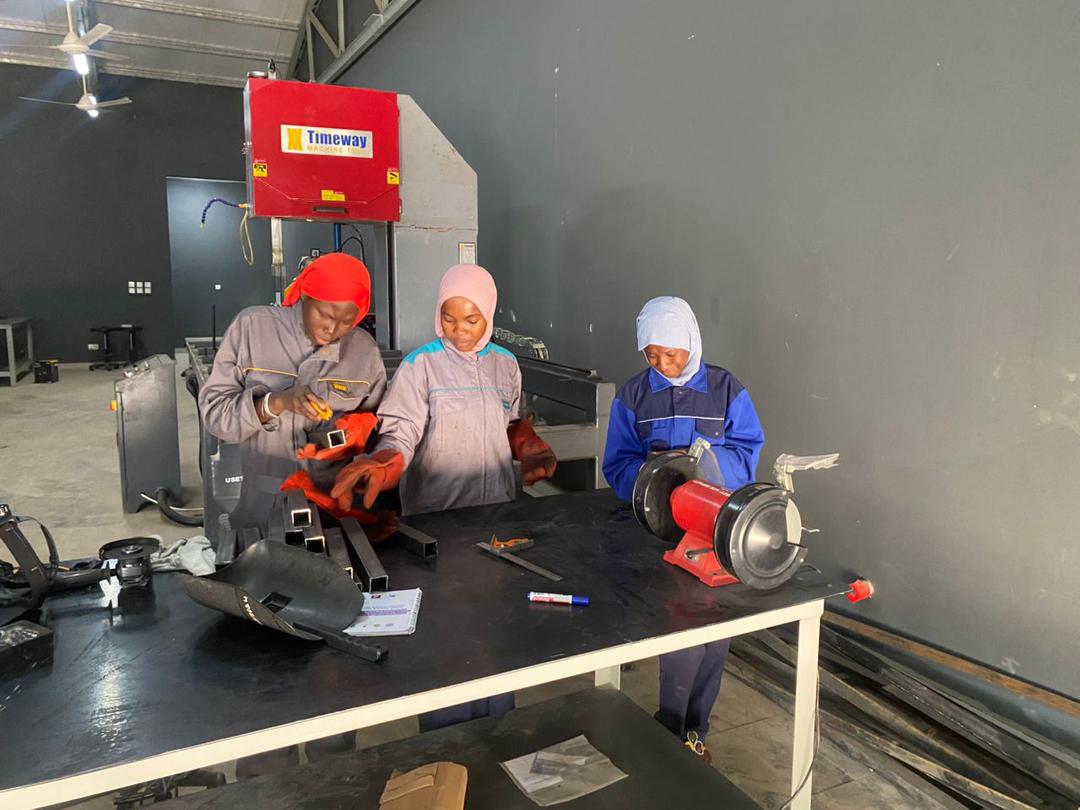ThreshWorks team fabricating machine components at the USET workshop